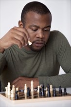 Black man playing chess