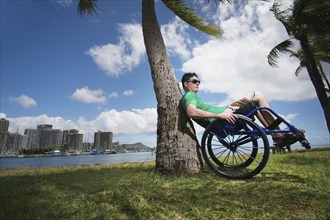 Disabled man playing in wheelchair on beach
