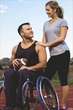 Paraplegic athlete in wheelchair with girlfriend