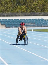 Man racing in wheelchair on track