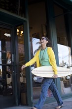 Mixed race woman carrying skateboard