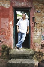 Hispanic man standing in doorway