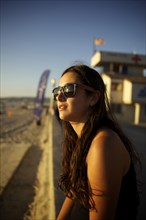Woman in sunglasses enjoying beach