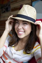 Smiling mixed race woman wearing hat
