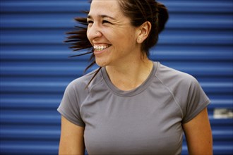 Athletic mixed race woman laughing outdoors