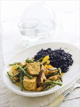 Tofu and vegetables on plate
