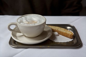 Latte and biscotti on tray