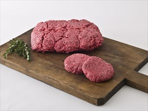 Raw hamburger meat on cutting board