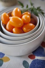 Tomatoes in stack of bowls
