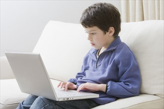 Hispanic boy using laptop