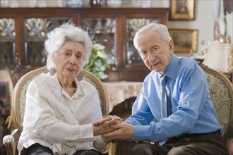 Senior Hispanic couple holding hands