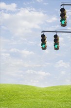 Green traffic lights over grass field