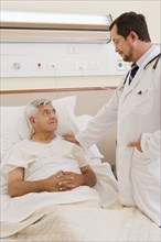 Doctor talking with patient in hospital room