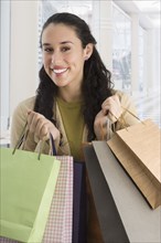 Mixed race woman shopping and carrying shopping bags