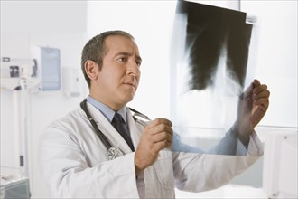 Hispanic doctor looking at x-rays