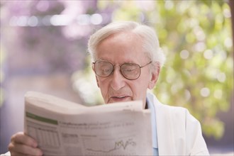 Senior Chilean man reading newspaper