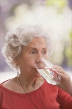 Senior Chilean woman drinking water