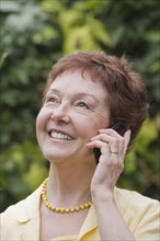 Senior Chilean woman using cell phone