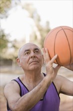Senior Chilean man playing basketball