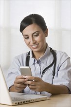 Turkish doctor text messaging on cell phone