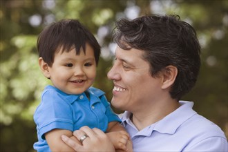 Smiling father holding baby boy