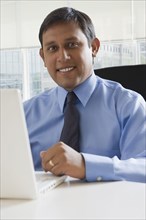 Hispanic business using laptop