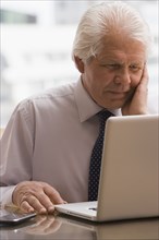 Chilean businessman working on laptop