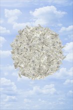 Illustration of globe of dollar bills in sky