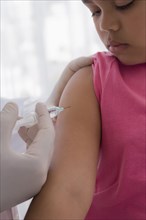 Hispanic doctor giving patient injection in arm