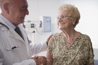 Hispanic doctor talking with older patient