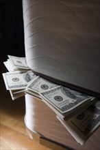 Dollar bills stuffed between mattresses
