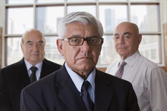 Hispanic businessmen standing in office