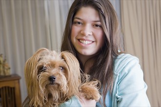 Hispanic girl holding dog