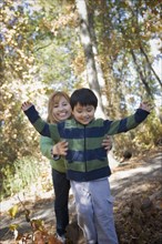 Hispanic mother and son playing in park