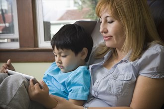 Hispanic mother reading to son