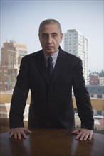 Portrait of serious Hispanic businessman in urban office