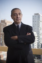 Portrait of confident Hispanic businessman in urban office