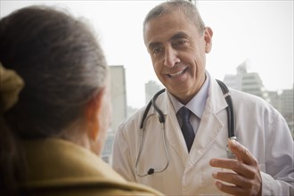 Hispanic doctor talking to patient