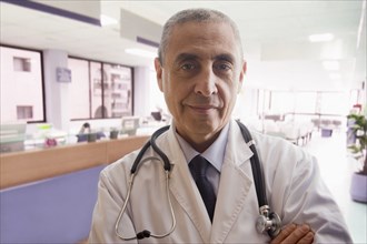 Close up portrait of confident Hispanic doctor in hospital