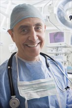 Close up portrait of smiling Hispanic surgeon