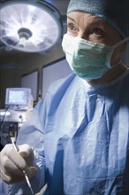 Hispanic surgeon working in operating room