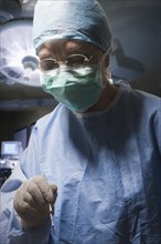 Hispanic surgeon working in operating room