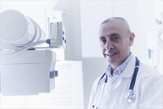 Hispanic doctor smiling in hospital