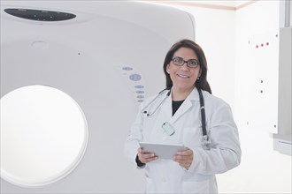 Hispanic doctor standing in MRI room