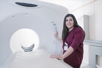 Hispanic doctor operating MRI machine