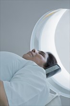 Hispanic patient laying in MRI machine