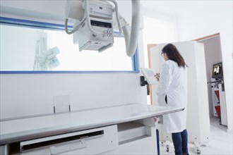 Hispanic doctor using x-ray in hospital