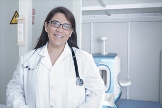 Hispanic doctor smiling in hospital
