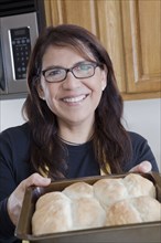 Hispanic woman baking in kitchen