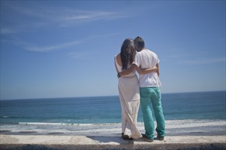 Hispanic couple admiring seascape at beach